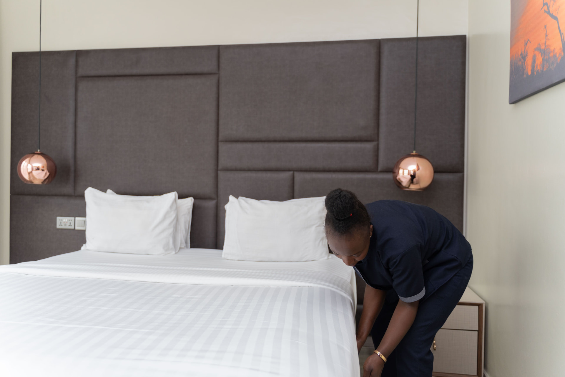 A housekeeper preparing a residence at The Graces