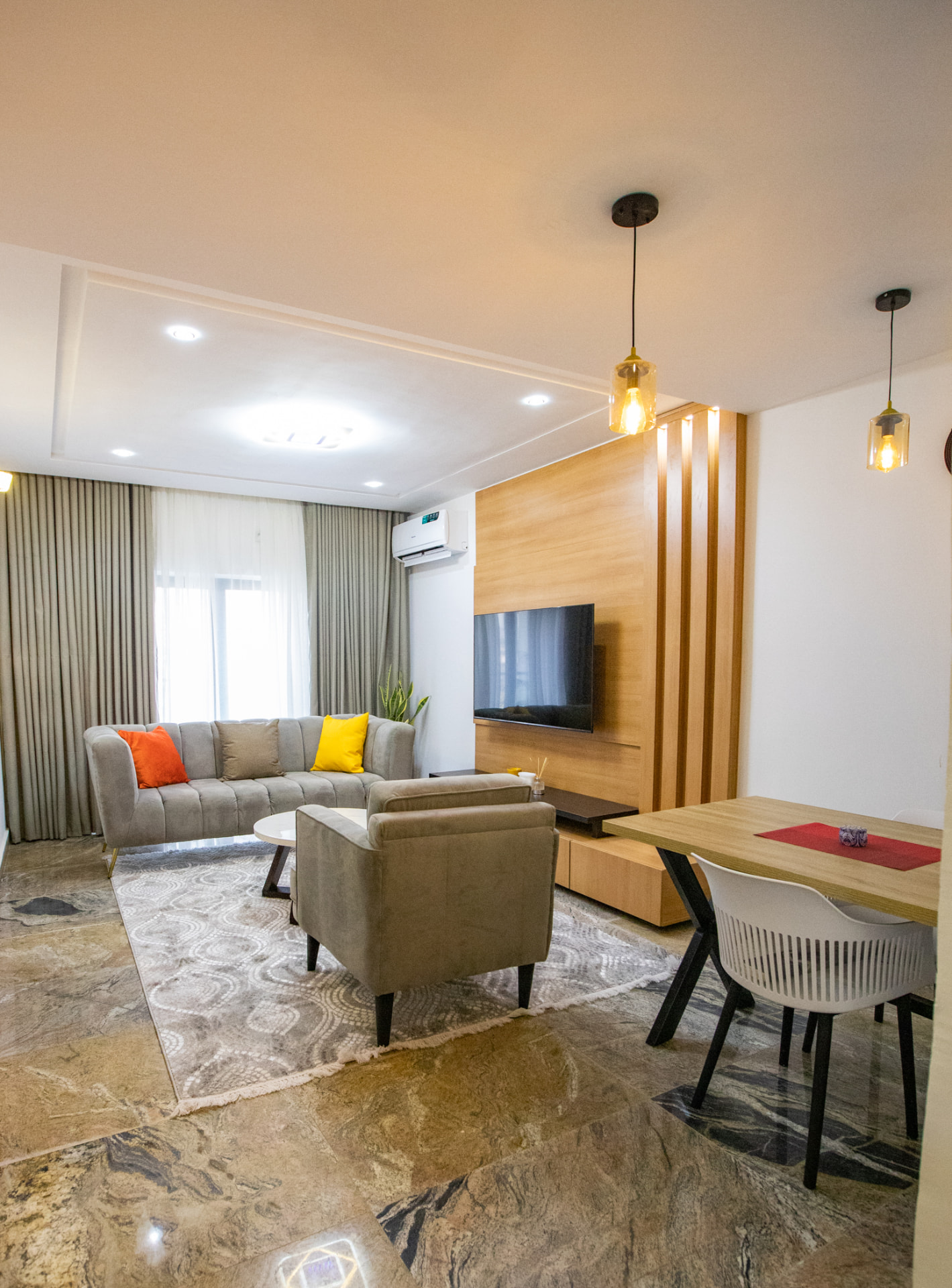 Open living and dining space with marble floors at The Graces — Dawn