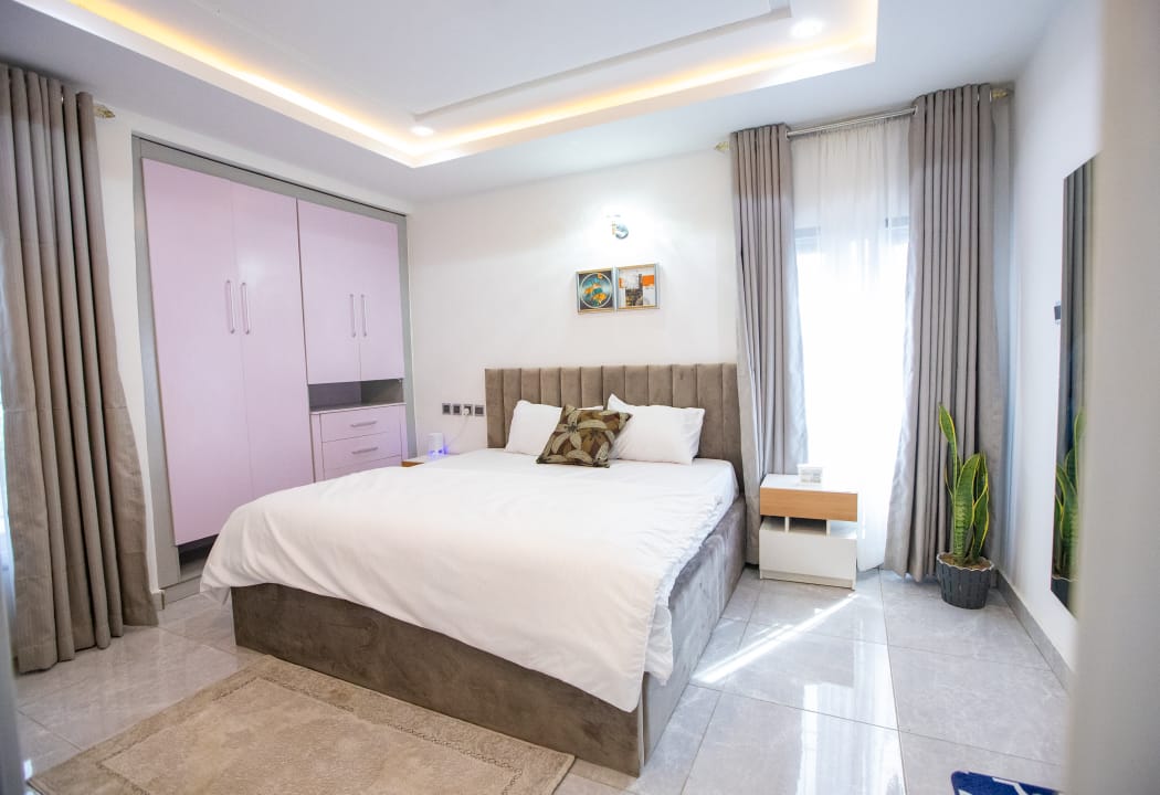 Bedroom with soft lighting and fitted wardrobes at The Graces — Dawn