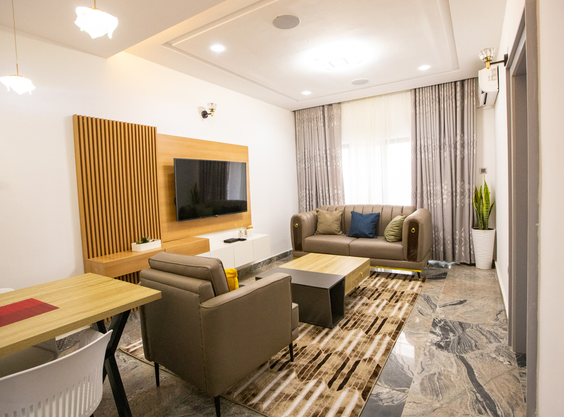 Lounge with armchairs, coffee table and workspace at The Graces — Dawn